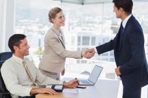 Business people shaking hands with their future patner in their office
